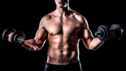 Obraz na płótnie Canvas Powerful Athlete Posing with weights