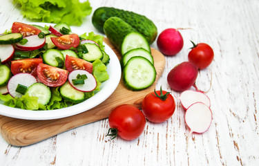 Spring salad with tomato, cucumbers and radish