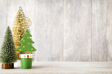 Artificial Christmas tree on a wooden background.