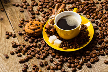 Coffee cup and saucer on a wooden table. Dark background, coffee