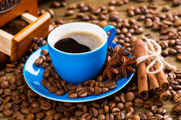 Coffee cup and saucer on a wooden table. Dark background, coffee