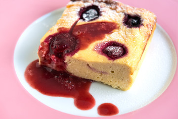 Cottage cheese pudding with cherries and fruit sauce. Close-up
