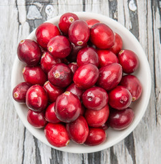 Cranberries fruit over wooden background