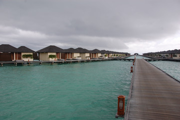 Fototapeta na wymiar Timber pier and bungalow at Paradise Island Resort Maldives