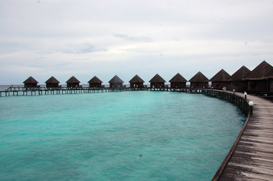 Timber pier and bungalow at Paradise Island Resort Maldives