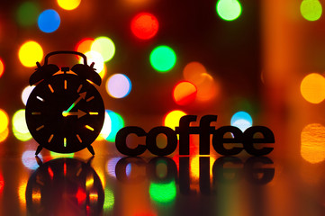 Silhouette of alarm clock and inscription of Coffee with garland lights on background. Concept "Time for coffee"