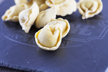 Agnolotti over black stone