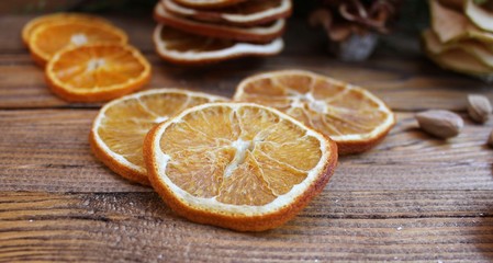 Dried slices of oranges on a wooden table
