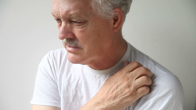 An older man with a persistent itch on his shoulder.