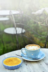 hot cappuccino and custard with vintage garden background
