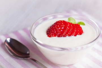 yogurt and strawberries on romantic background