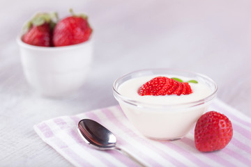 yogurt and strawberries on romantic background