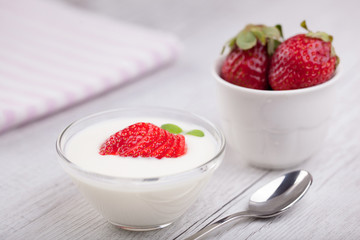 yogurt and strawberries on romantic background