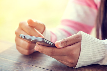 Close up of a woman using mobile smart phone