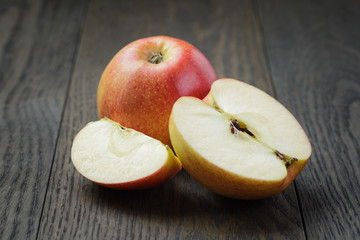 ripe gala apples sliced on wood table