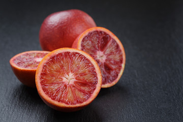 red sicilian oranges sliced on slate board