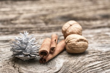 Vintage Christmas Composition with Sticks of Cinnamon, pine cones and walnuts