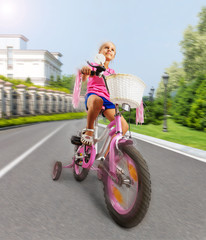 Fototapeta premium Little girl cycling