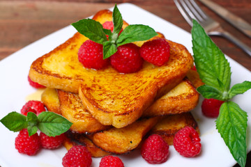 delicious French toast with raspberries and honey