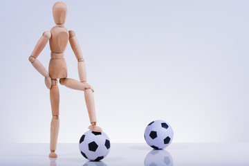 Wooden puppets playing soccer