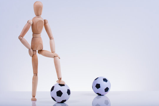 Wooden puppets playing soccer