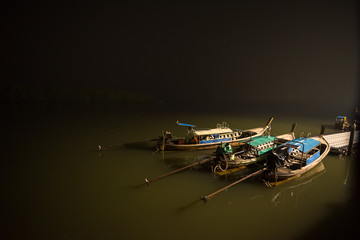 three taxi boat park at pier