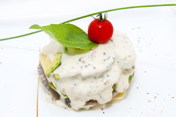 Herring salad with avocado sauce on a plate in a restaurant