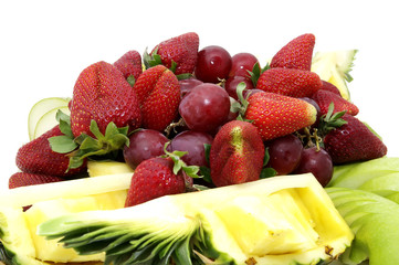 a large plate of sliced fruit on white background