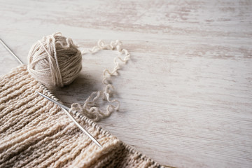 Ball of yarn and knitting on a table