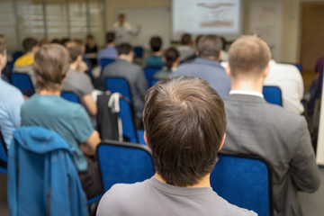 Fototapeta premium Back view of audience ina business conference