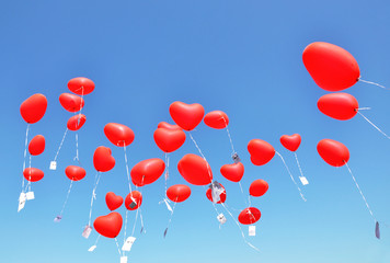 Red ballons with the messages in the blue sky