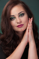 Fototapeta premium Girl with green eye shadows, make-up, facial stones crystals