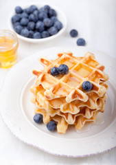 Fresh waffles with blueberries, maple syrup Breakfast table