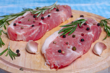 fresh raw meat with rosemary and pepper
