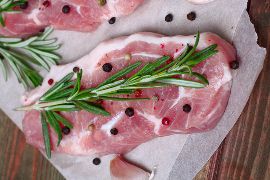 fresh raw meat with rosemary and pepper