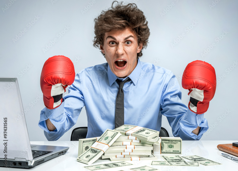 Wall mural boxing gloves businessman happy - business concept showing aggressive male businessperson flexing mu