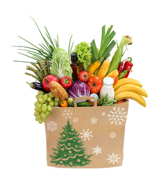 Christmas Holiday shopping bag / studio photography of brown grocery bag with fruits, vegetables, bread, bottled beverages - isolated over white background. High resolution product