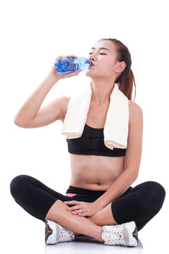 Fitness beautiful woman drinking water on white background