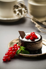 Chocolate tart with red currant on a plate