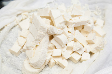 Closeup of paneer cut into pieces on buttercloth