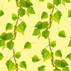 Yellow cheerful backdrop with spring green birch leaves 