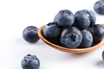Fresh blueberries in wooden spoon