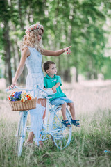 beautiful woman rolls the baby on the big bike