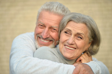 Mature couple near wall