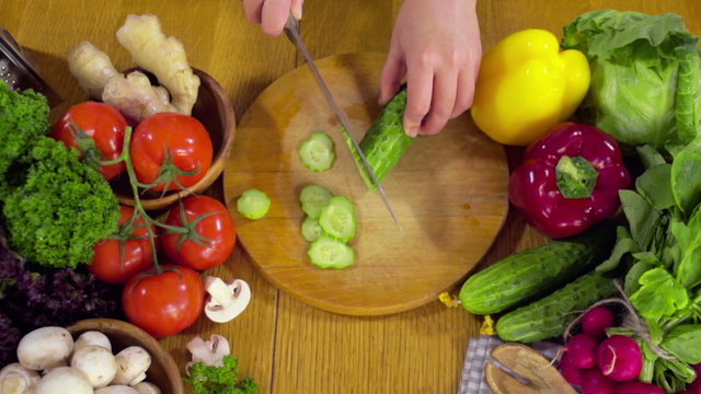 chef chopping a cucumber for a salad slow motion