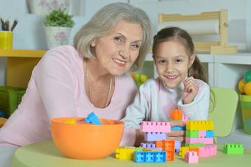 Grandmother with granddaughter playing together