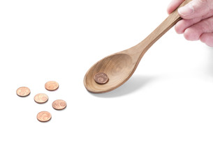 Coins on a wooden spoon. Saving money for you