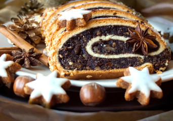 Christmas poppy seed cake on a plate with decoration
