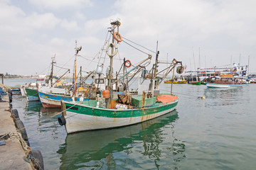 Wooden yachts moored in harbor against cloudy sky background. Acre, Israel.
