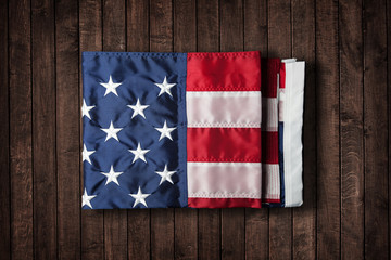  USA flag folded on grunge wood panels